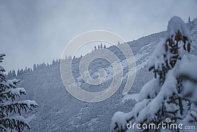 Snowy mountain ridge and cloudy sky Stock Photo