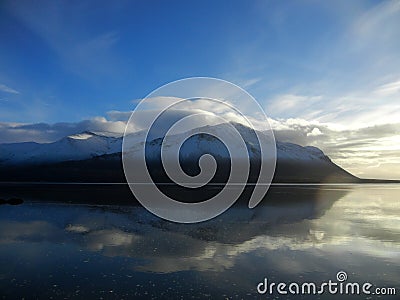 Snowy mountains mirrored in a fjord Stock Photo