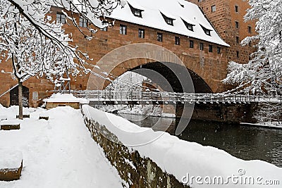 Snowy Nuremberg, Germany- iron bridge ( Kettensteg), old town city walls Stock Photo