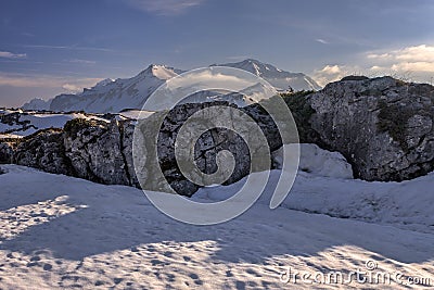 Snowy Oshten mountain peak on background at Lagonaki Highlands in West Caucasus. Scenic winter spring sunny day bluesky landscape Stock Photo