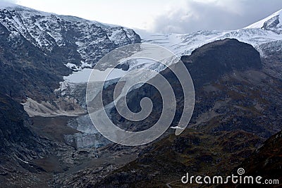 Snowy peaks, glacier and lake on San Gotthard Pass Stock Photo