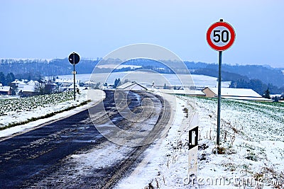 snowy, slippery road into Welling, Eifel in winter Stock Photo