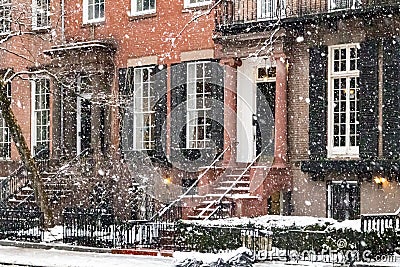 Snowy street scene with the historic buildings along Washington Square Park during a winter noreaster storm in New York City Stock Photo