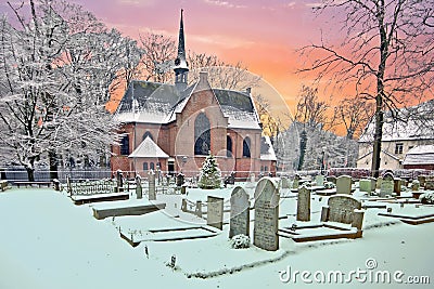 Snowy traditional medieval church in Lage Vuursche Netherlands Stock Photo