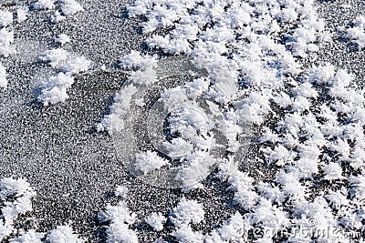 Snowy white background with frosty crystals and curly snowflakes close-up. Winter is a cold season with a blinding white bright Stock Photo