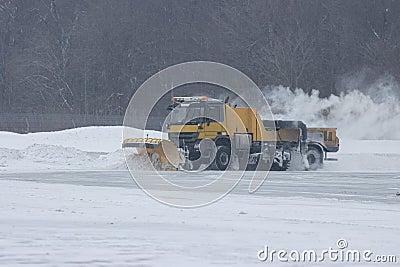 Snowy winter at the airport and snowplow removes snow Stock Photo