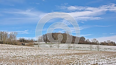 Snow covered fields with trees in the Flemish countryside Stock Photo