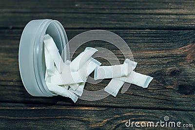 Snus box with nicotine pouches on wooden background. Stock Photo