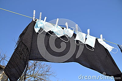 Soaked masks drying under the sun Stock Photo