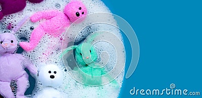 Soaking rabbit dolls with bear toys in laundry detergent water dissolution before washing. Laundry concept, Top view Stock Photo