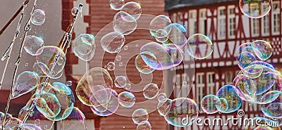 Soap bubbles with deliberately blurred half-timbered buildings in the background Stock Photo