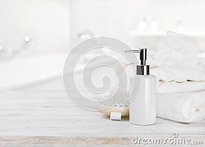 Soap dispencer, towels, massager and wisp of bast over blur Stock Photo