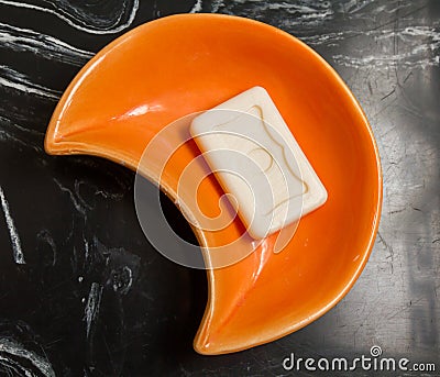 Soap in orange ceramic dish. Stock Photo