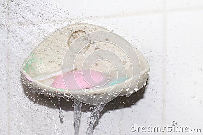 Soap, water splash and soap bar on dish at wall, soap cubes used selective focus Stock Photo