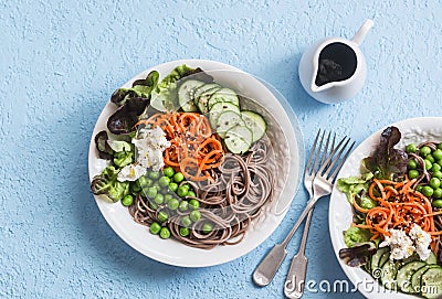 Soba noodles buddha bowl. Buckwheat noodles with vegetables on a blue background, top view. Vegetarian healthy food Stock Photo