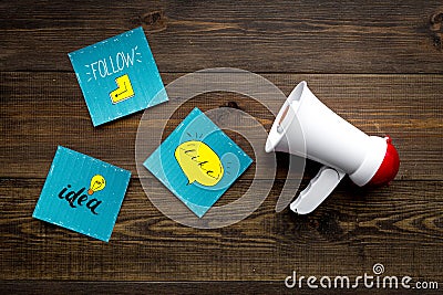 Socail media announcements concept. Megaphone near social media icons on dark wooden background top view Stock Photo