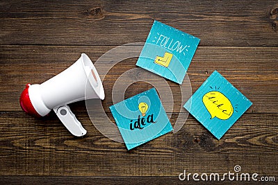 Socail media announcements concept. Megaphone near social media icons on dark wooden background top view Stock Photo