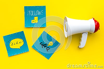 Socail media announcements concept. Megaphone near social media icons on yellow background top view Stock Photo
