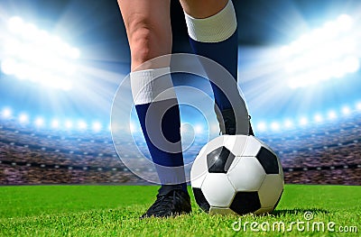 Soccer ball and foots of football player Stock Photo