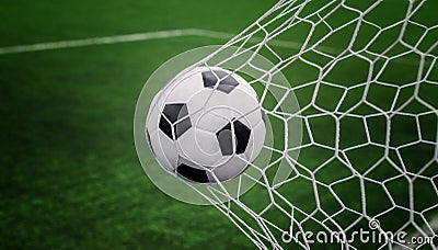 Soccer ball on goal with net and green background Stock Photo