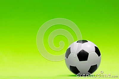 Soccer ball isolated against a plain green background. Stock Photo