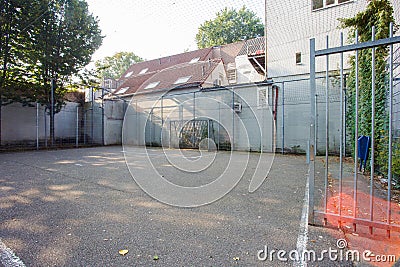 Soccer cage in the city, iron gate protection grid with soccer court behind it, empty Stock Photo