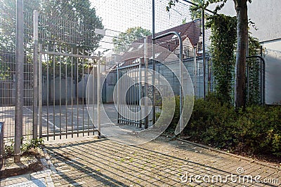 Soccer cage in the city, iron gate protection grid with soccer court behind it, empty Stock Photo