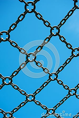 Soccer cage goal, blue sky, net grid imprisoned Stock Photo