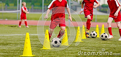 Soccer camp for kids. Boys practice dribbling in a field. Players develop good soccer dribbling skills Stock Photo