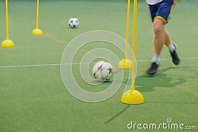 Soccer camp for kids. Children training soccer skills with balls and cones. Soccer slalom drills to improve football dribbling fas Stock Photo