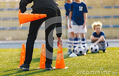 Soccer Coach Placing Training Cones for Kids Sports Team. Children on Soccer Football Class Stock Photo