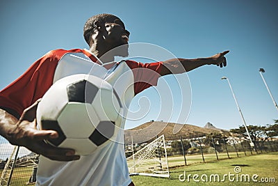 Soccer, football player and black man on a sports field with ball for game or match. Fitness, happy captain male and Stock Photo