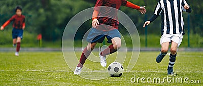 Soccer football players chasing ball on field Stock Photo