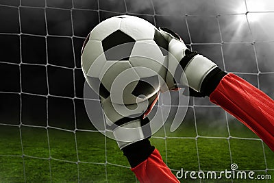 Soccer goalkeeper catches the ball Stock Photo