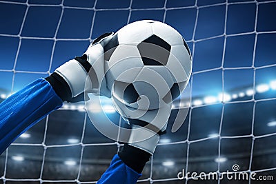 Soccer goalkeeper catches ball on the stadium Stock Photo