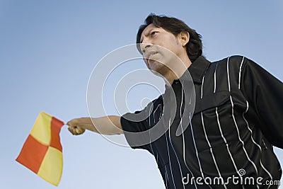Soccer linesman waving flag Stock Photo