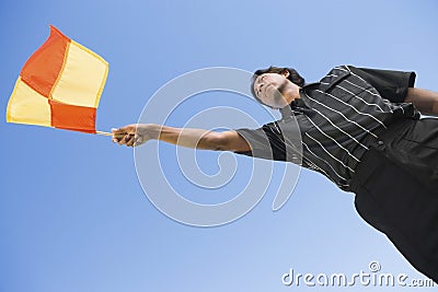 Soccer Linesman Waving Flag Stock Photo