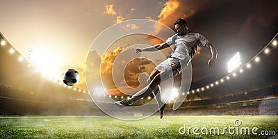 Soccer player in action on sunset stadium panorama background Stock Photo