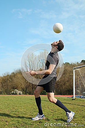 Soccer Player Juggle The Ball With His Head Stock Photo