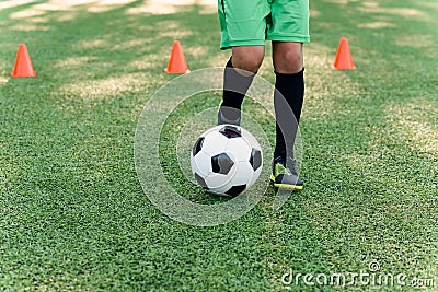Detail soccer player kicking ball on field. Soccer players on training session. Detail soccer background. Close up of Stock Photo