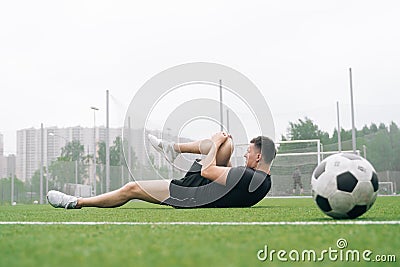 Soccer player A man holds his knee. Dislocation of the knee joint Stock Photo