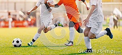 Soccer Shot. Young Boys Kicking Football Soccer Tournament Match on the Grass Pitch. Football Players Duel Stock Photo