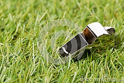 Soccer sports chrome whistle on grass background - penalty, foul or sports concept Stock Photo