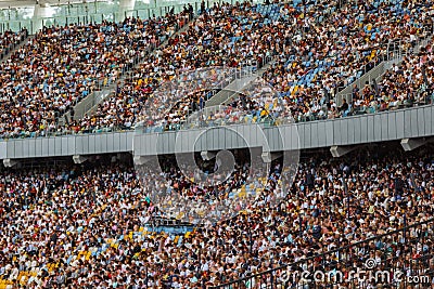 Soccer stadium inside view. football field, empty stands, a crowd of fans, a roof against the sky Editorial Stock Photo