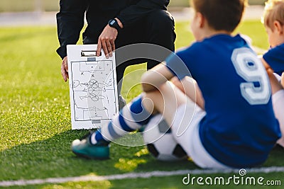 Soccer Team Meeting. Coach Giving Tactic Advices Using Football White Board Stock Photo