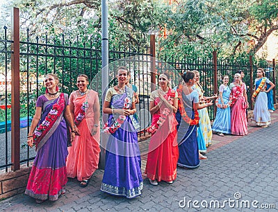 beautiful and happy women and girls are hare Krishna in bright dresses dancing and singing on the streets of Sochi in the summer Editorial Stock Photo