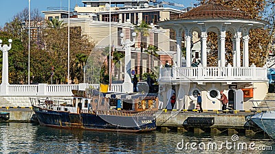 Beautiful view to Embankment near Sochi Commercial Sea Port with boat and white gazebo rotunda. Editorial Stock Photo