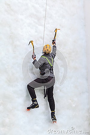 Man ice climber about to climb ice wall at ice climbing side-show attraction in Olympic Park in Sochi Editorial Stock Photo