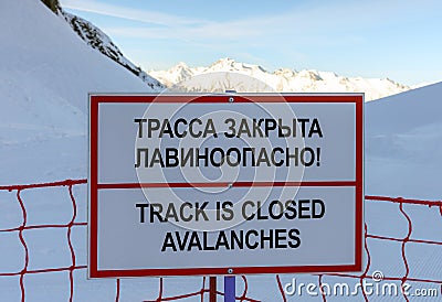 Sochi, Russia - January 7, 2018: No skiing track closed avalanche danger information sign in Gorky Gorod ski resort on snowy winte Editorial Stock Photo