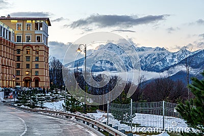 Sochi, Russia - January 6, 2018: Twilight townscape of Gorky Gorod mountain ski resort on snowy mountain peak background Editorial Stock Photo